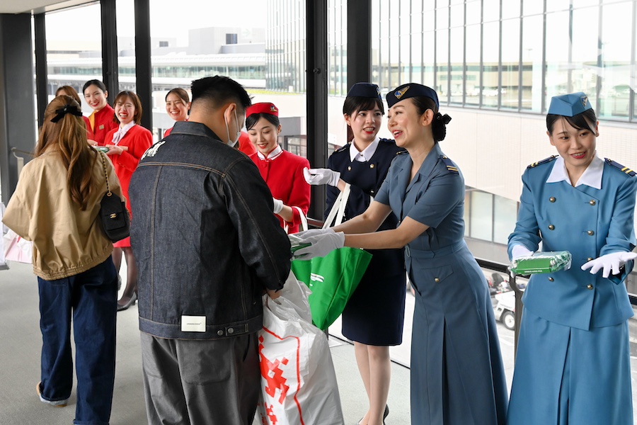 Cathay Pacific cabin crew wearing various retro uniforms at Narita