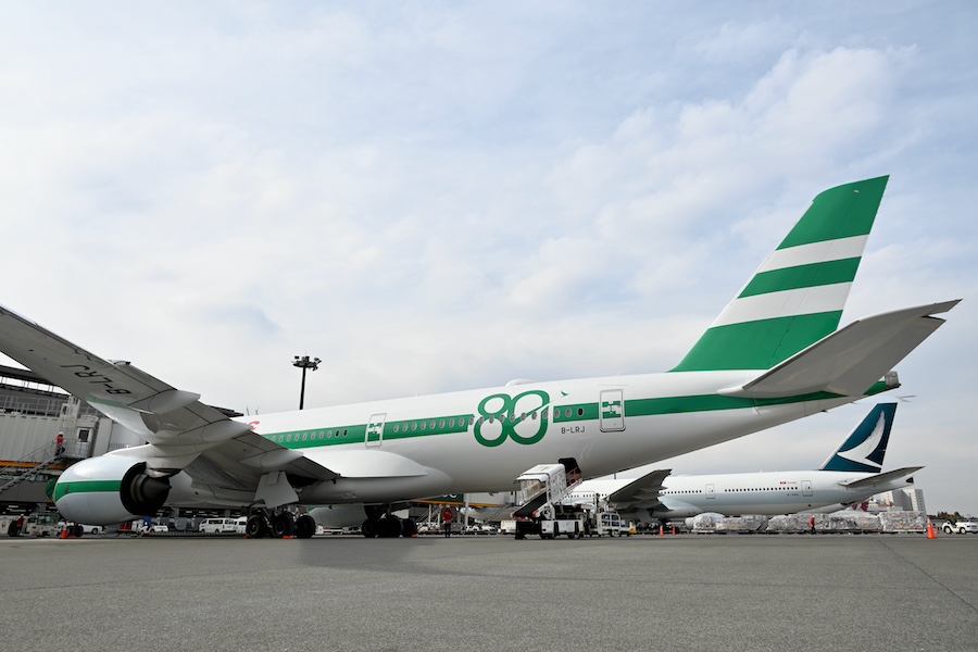 Passengers being welcomed at Narita by staff in Cathay Pacific retro uniforms
