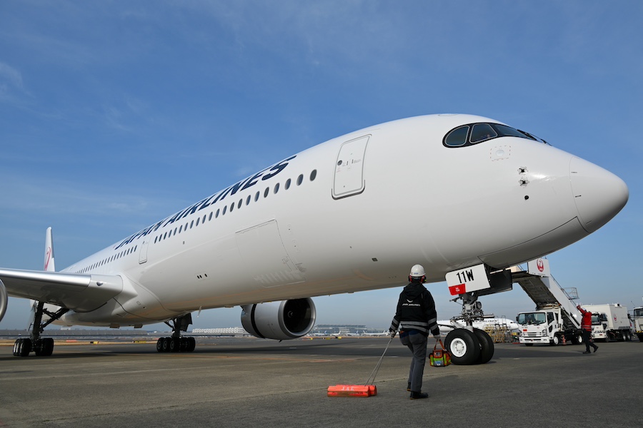 JAL staff and Airbus A350-1000 at Tokyo Haneda hangar area
