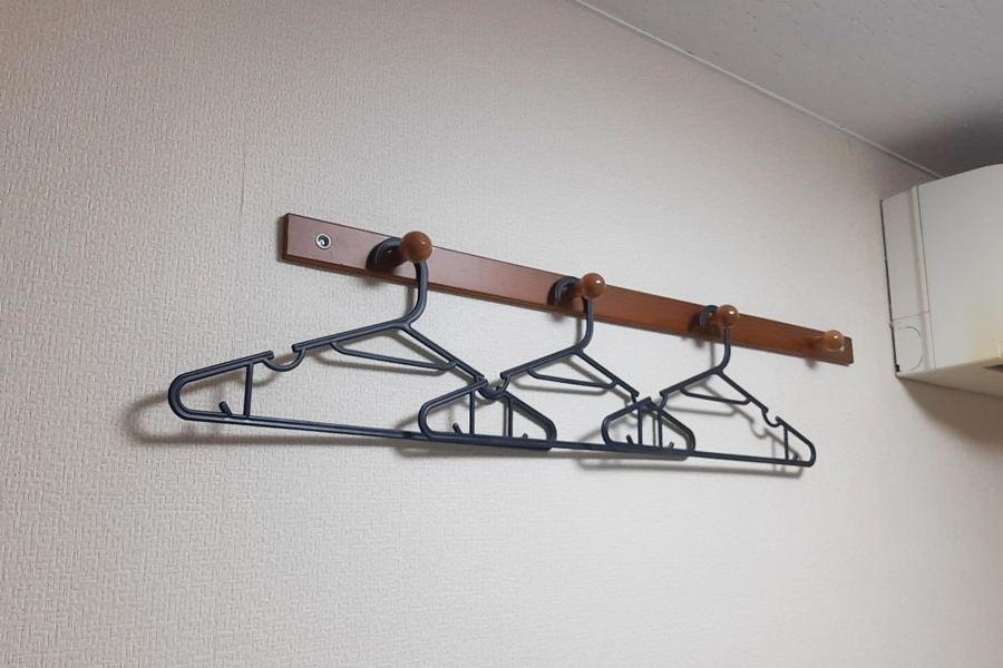 Hangers and storage space in a guest room at Hotel Lucky