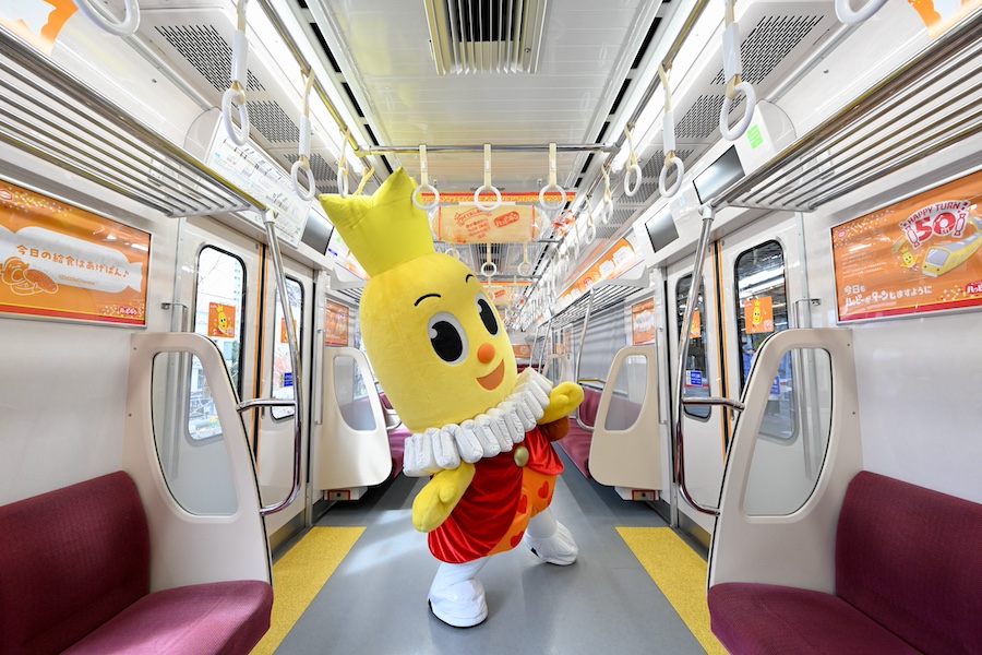 Side view of the Happy Turn Train running in Japan