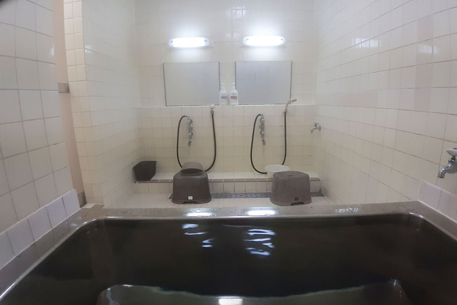 Inside the public bath at Hotel Lucky with shampoo and body soap
